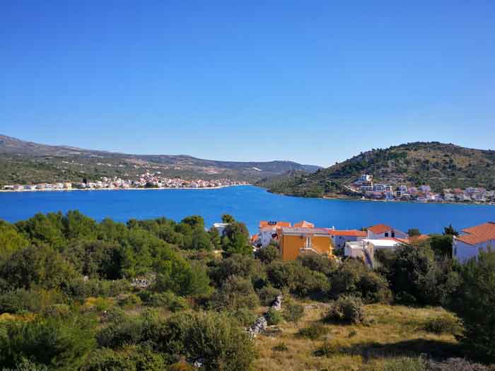 View from the hillside across the blue bay towards Rogoznica